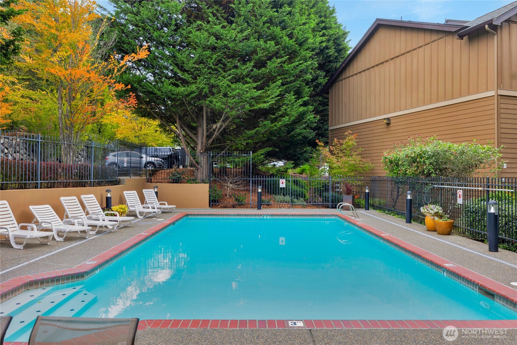 18930 Bothell Everett Highway, Unit B304 Bothell, WA 98012 - Photo 32 of 35 a view of a backyard with swimming pool