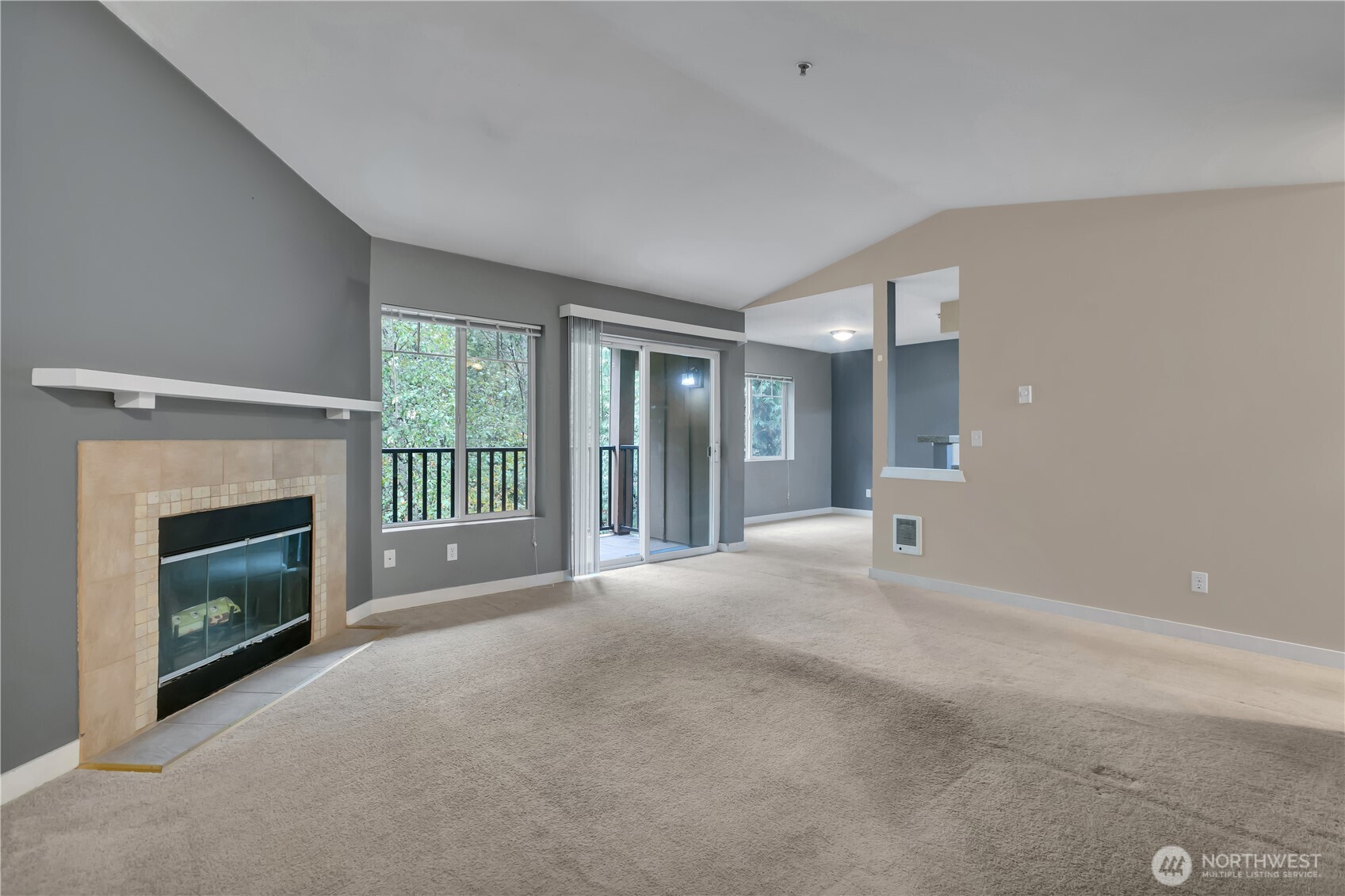 18930 Bothell Everett Highway, Unit B304 Bothell, WA 98012 - Photo 4 of 35 a view of an empty room with a fireplace and a window