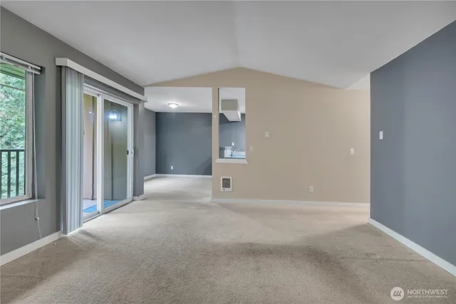 a view of an empty room with a fireplace