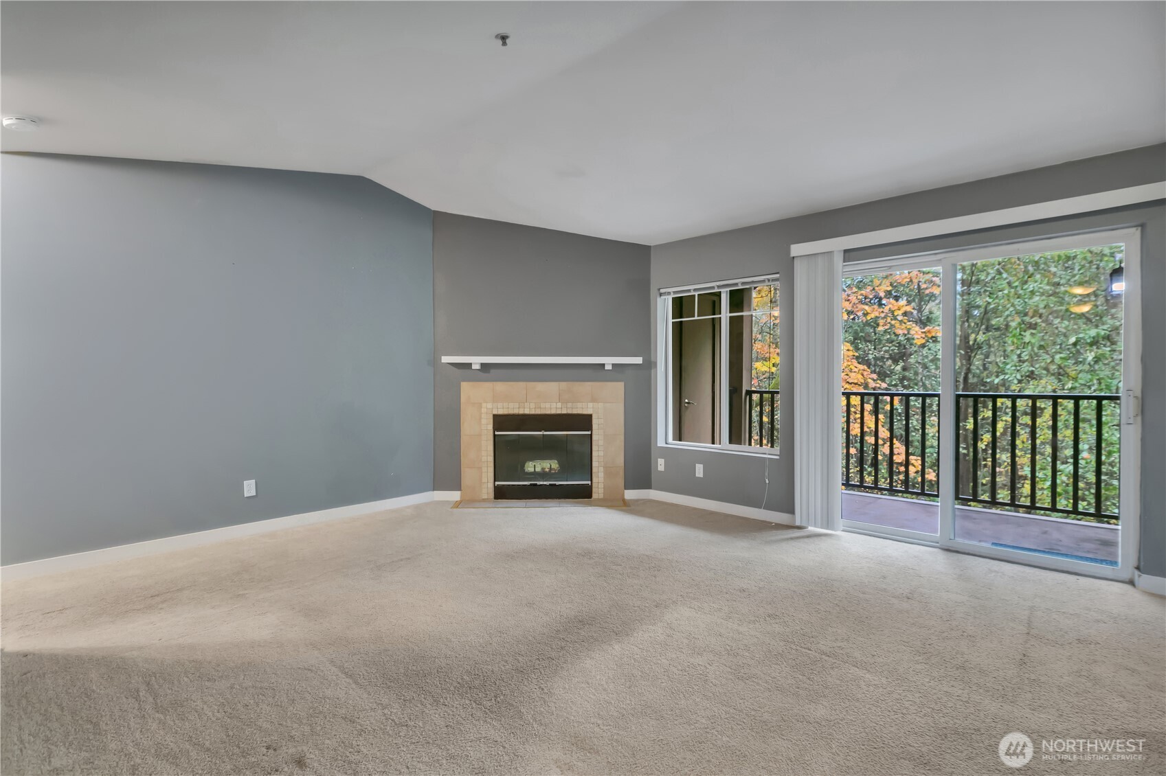 18930 Bothell Everett Highway, Unit B304 Bothell, WA 98012 - Photo 7 of 35 a view of an empty room with a fireplace and a window