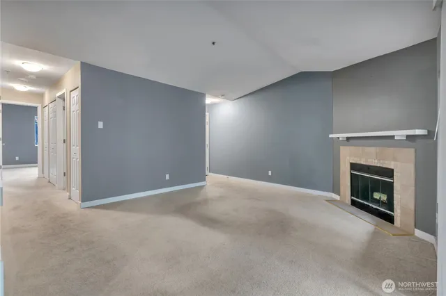 a view of empty room with a fireplace