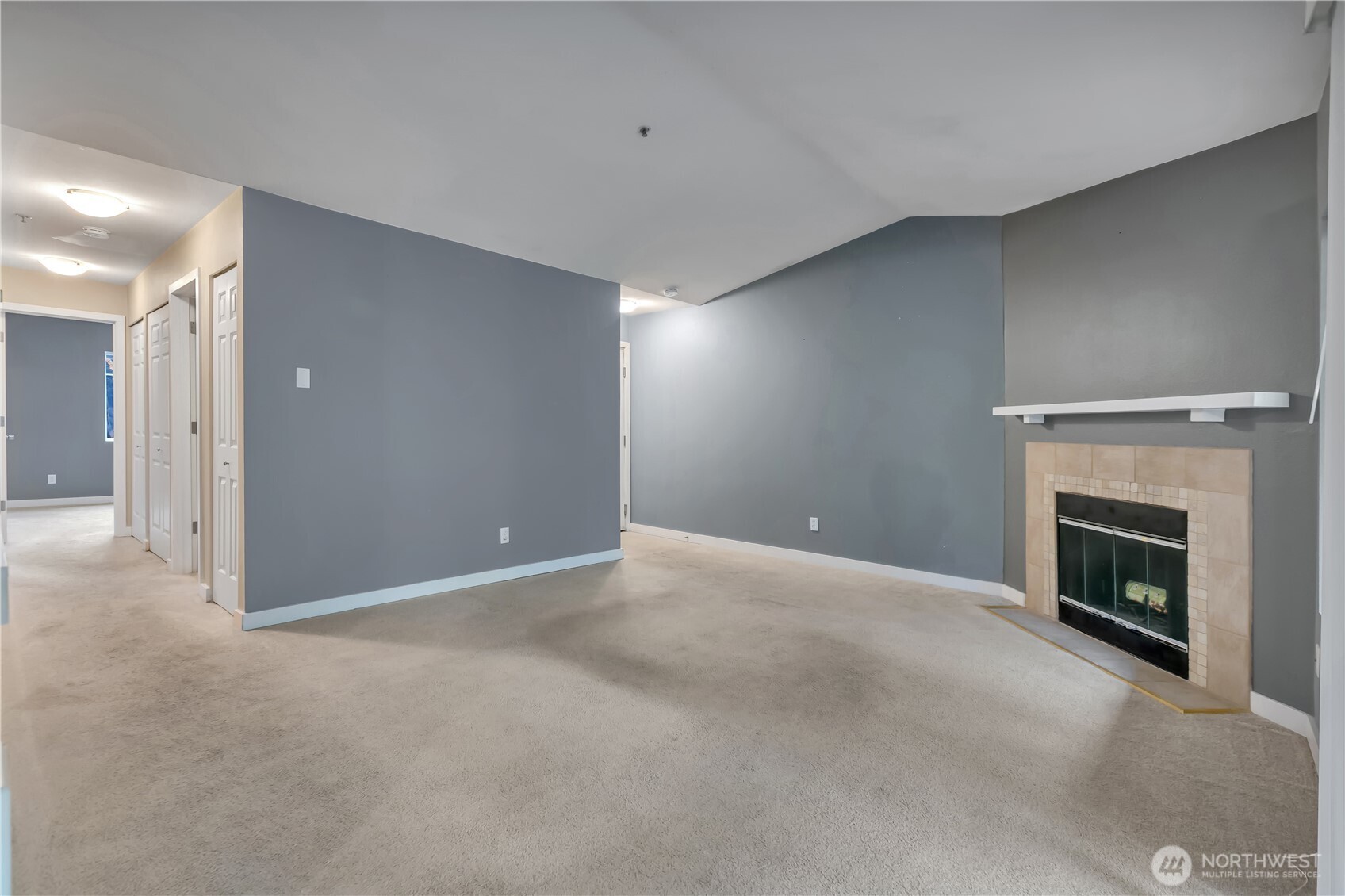 18930 Bothell Everett Highway, Unit B304 Bothell, WA 98012 - Photo 8 of 35 a view of empty room with a fireplace