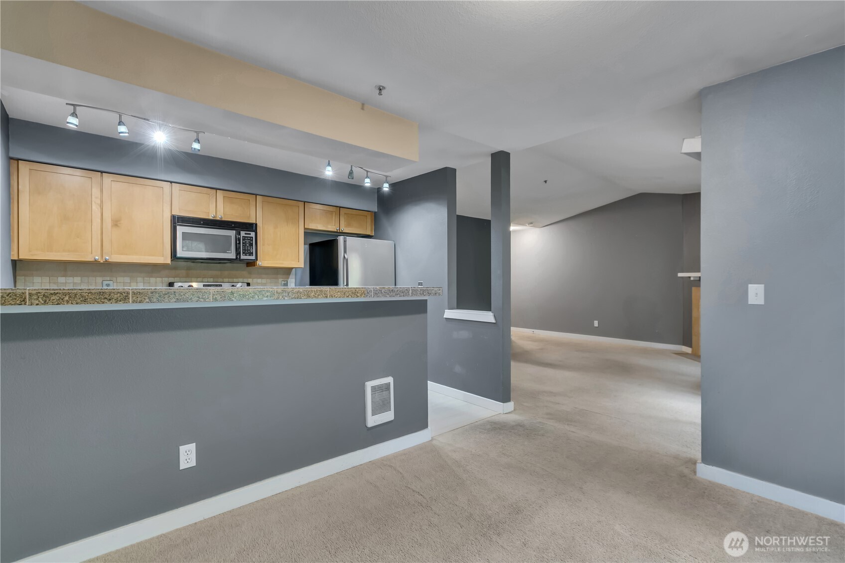 18930 Bothell Everett Highway, Unit B304 Bothell, WA 98012 - Photo 10 of 35 a view of a kitchen with a sink and a refrigerator