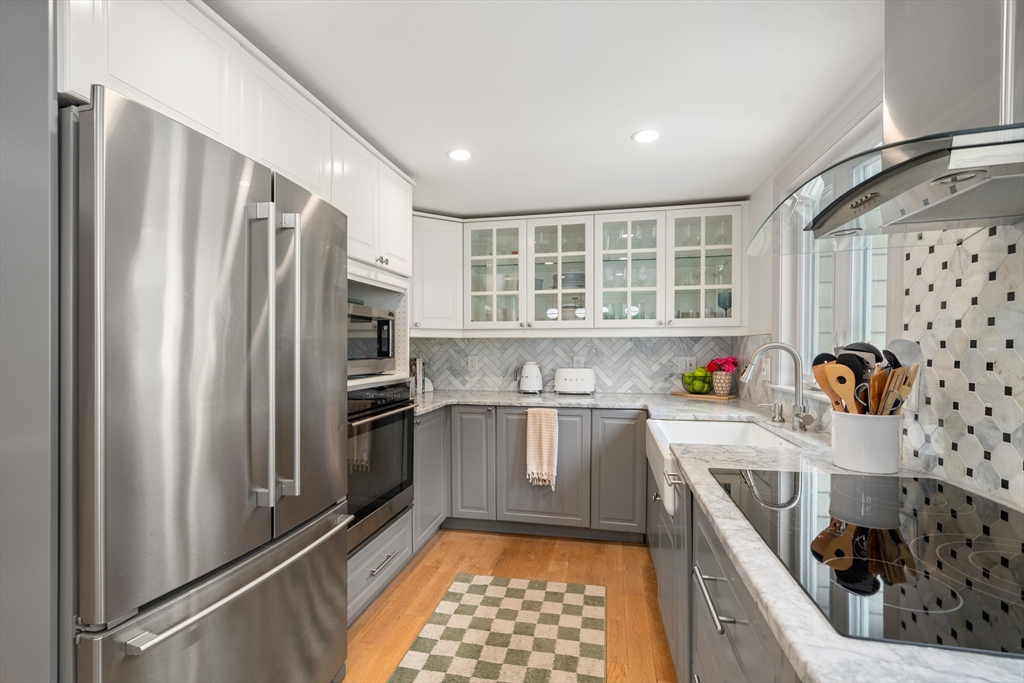 57 Marlboro Road Sudbury, MA 01776 - Photo 4 of 40 a kitchen with stainless steel appliances granite countertop a refrigerator and a stove top oven