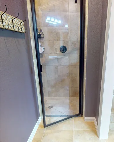 a bathroom with a glass shower door