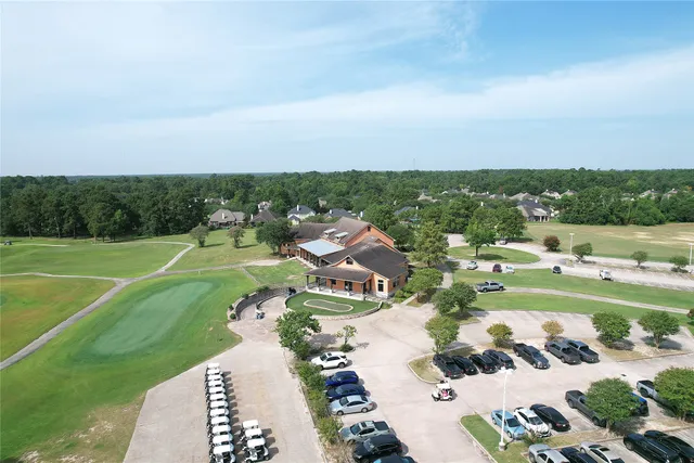 an aerial view of a house with a yard and large trees