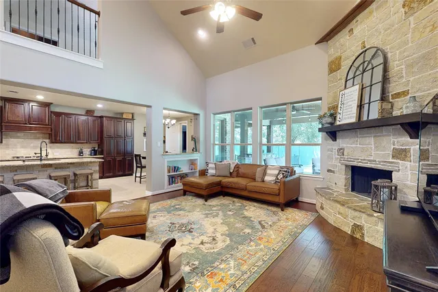 a living room with fireplace furniture and a large window
