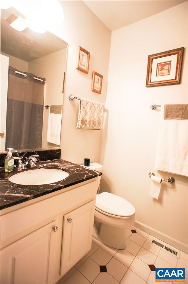 532 Watson Road Ruckersville, VA 22968 - Photo 13 of 21 a bathroom with a granite countertop sink mirror vanity and toilet