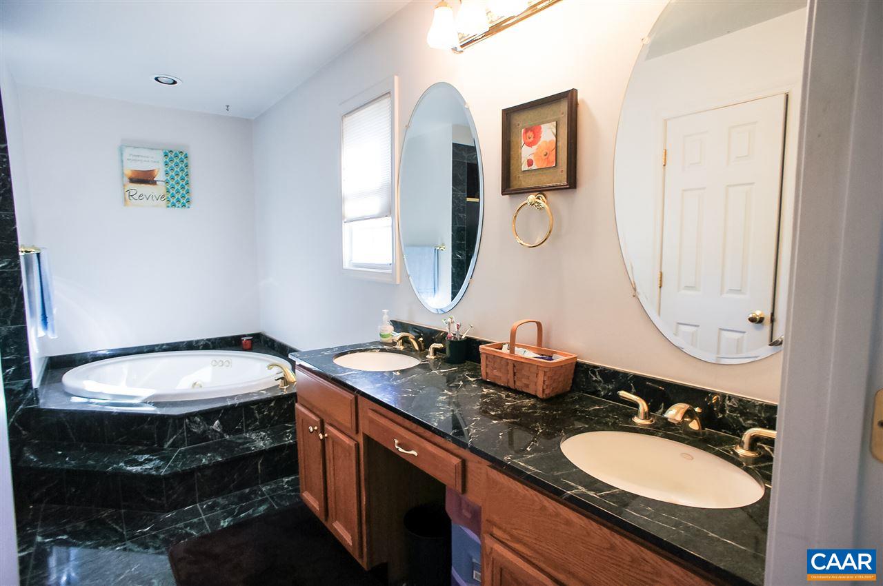 532 Watson Road Ruckersville, VA 22968 - Photo 15 of 21 a bathroom with a granite countertop double vanity sinks and a mirror