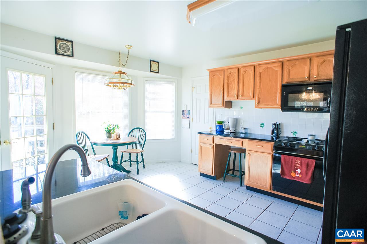532 Watson Road Ruckersville, VA 22968 - Photo 9 of 21 a kitchen with granite countertop a stove a sink and a microwave