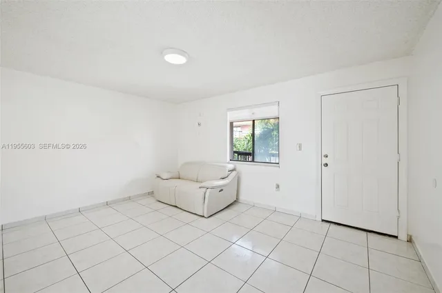 a view of empty room with white walls