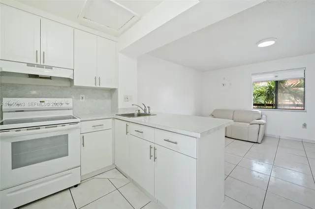 a white refrigerator freezer sitting inside of a kitchen