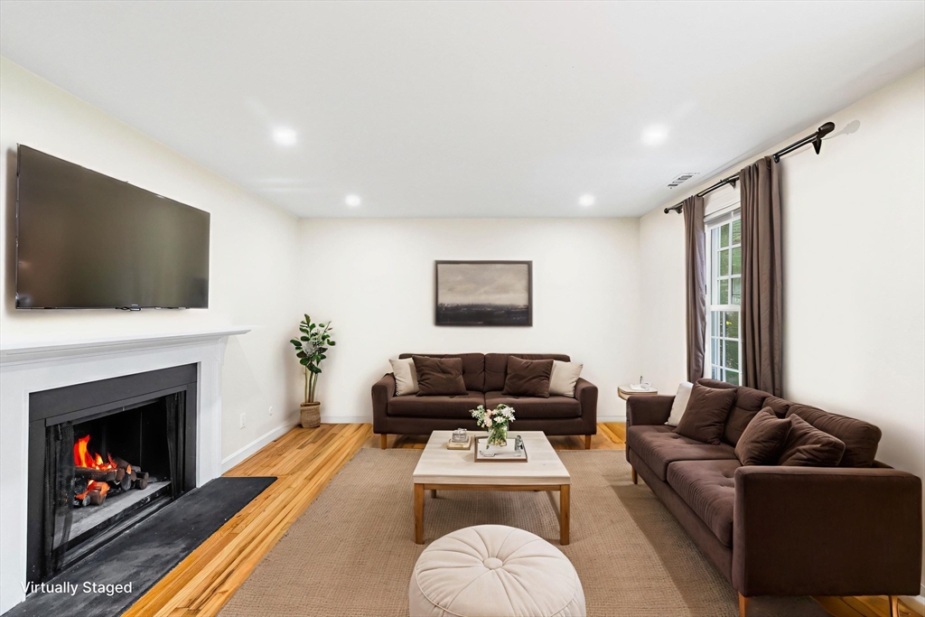 24 Jericho Road, Unit 24 Weston, MA 02493 - Photo 13 of 36 a living room with furniture a flat screen tv and a fireplace