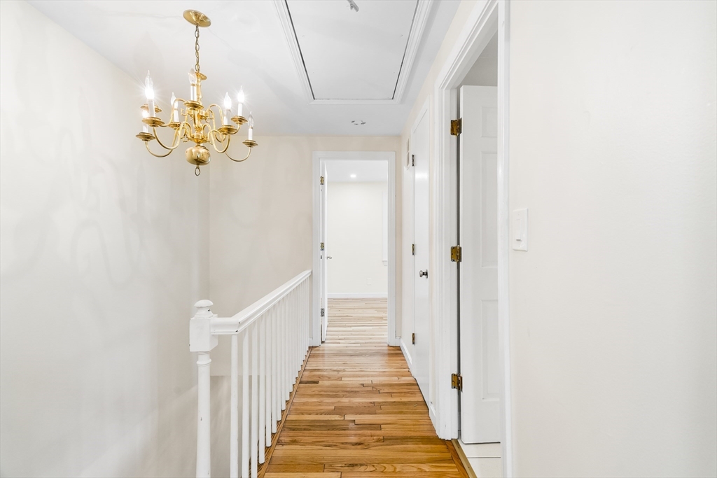 24 Jericho Road, Unit 24 Weston, MA 02493 - Photo 16 of 36 a view of a hallway with wooden floor