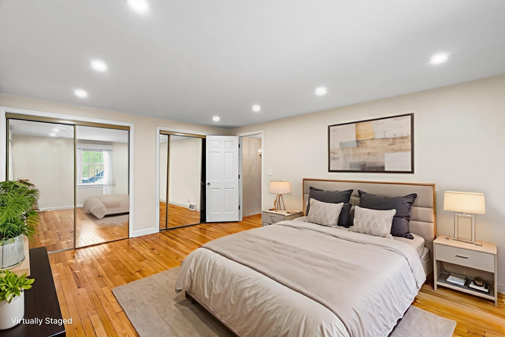 24 Jericho Road, Unit 24 Weston, MA 02493 - Photo 18 of 36 a bedroom with a large bed and a couch