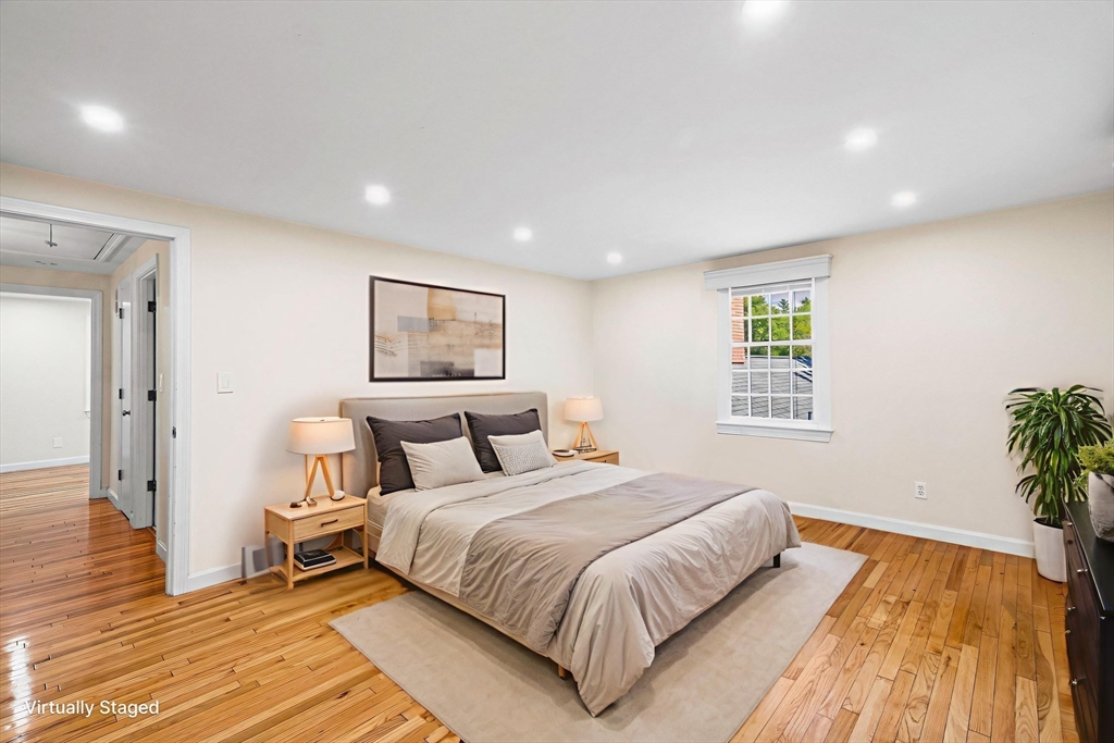 24 Jericho Road, Unit 24 Weston, MA 02493 - Photo 20 of 36 a bedroom with a large bed and a potted plant