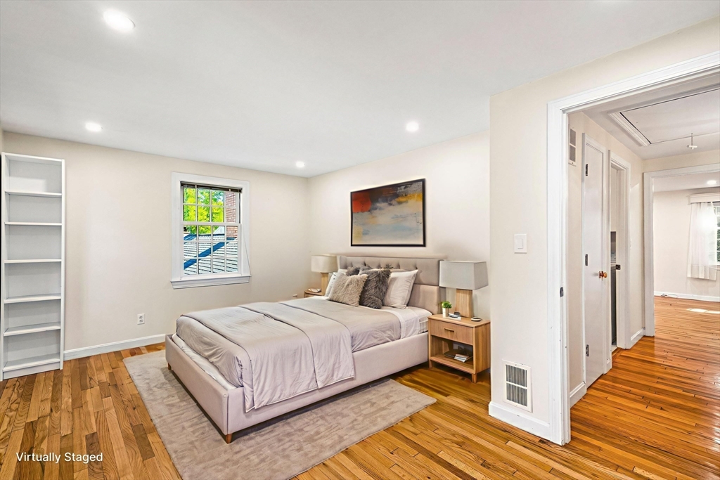 24 Jericho Road, Unit 24 Weston, MA 02493 - Photo 23 of 36 a bedroom with a bed and a painting on the wall