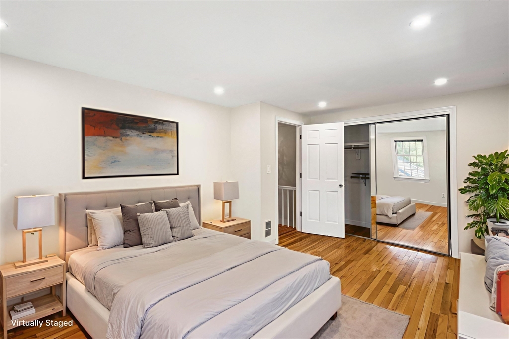 24 Jericho Road, Unit 24 Weston, MA 02493 - Photo 25 of 36 a bedroom with a bed and wooden floor