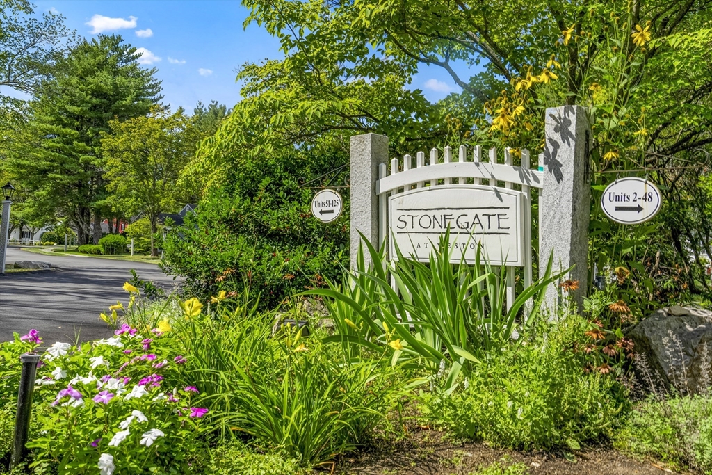 24 Jericho Road, Unit 24 Weston, MA 02493 - Photo 31 of 36 a sign that is sitting in a garden