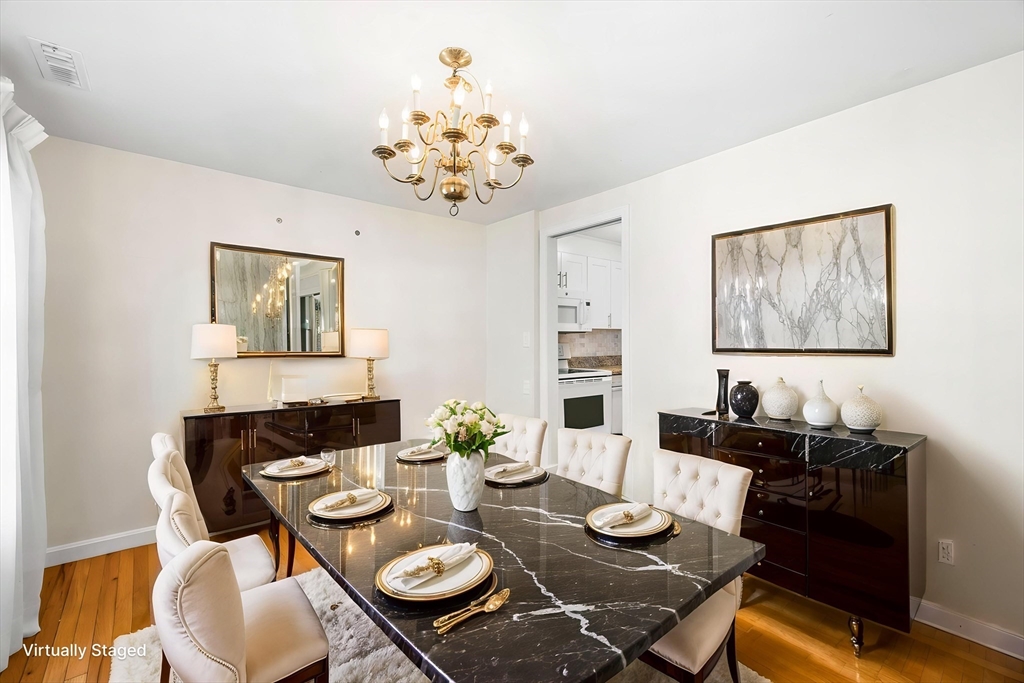 24 Jericho Road, Unit 24 Weston, MA 02493 - Photo 6 of 36 a view of a dining room with furniture wooden floor and a chandelier