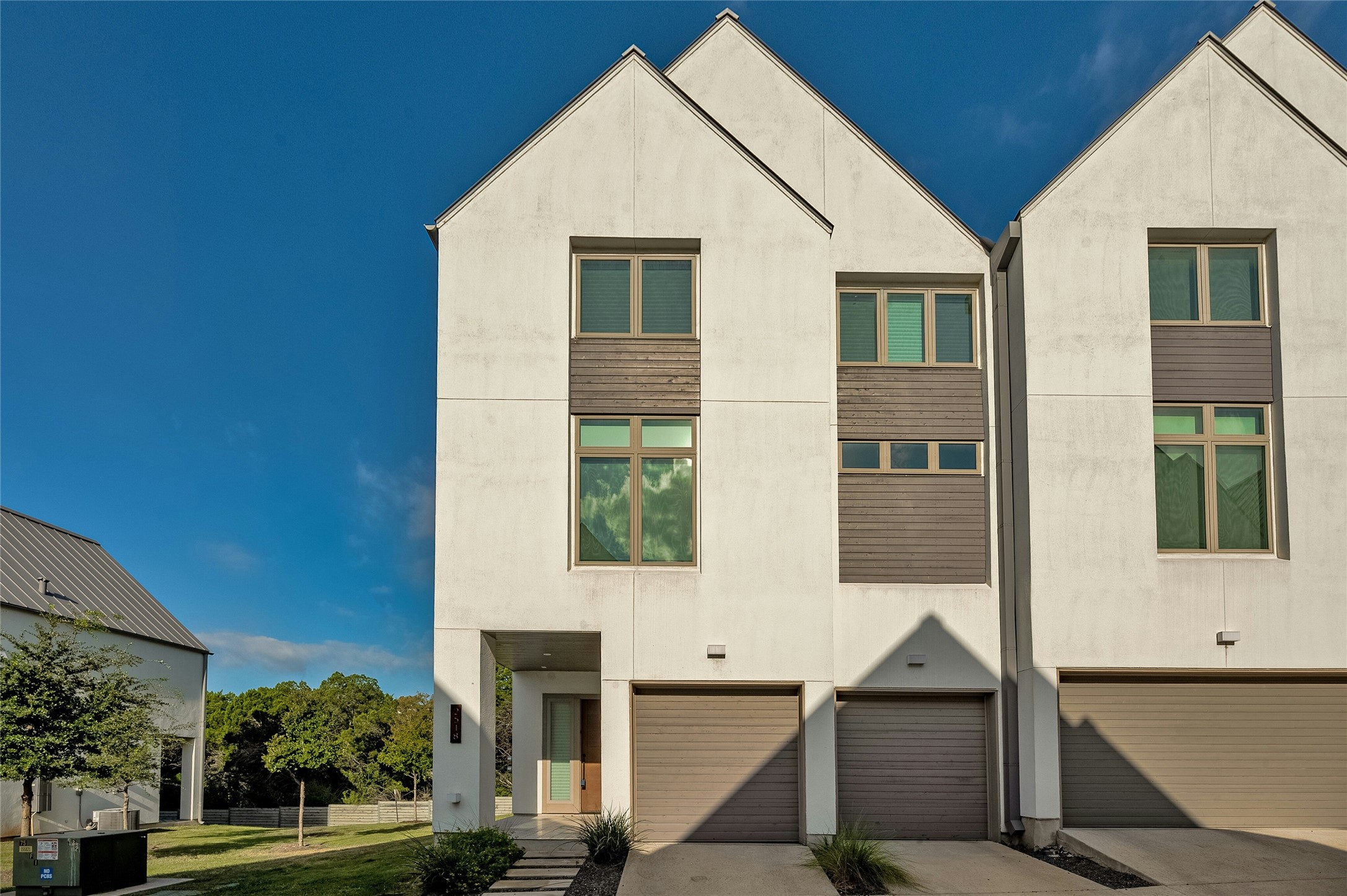 2518 Sutherland Street Austin, TX 78746 - Photo 2 of 30 Clean lines and a modern facade define this stylish urban townhome with individual garage access.