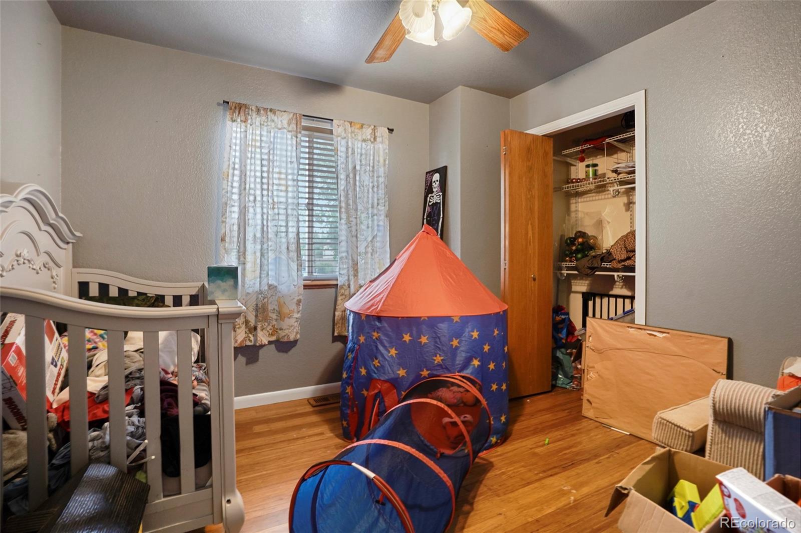 1200 7th Street Fort Lupton, CO 80621 - Photo 12 of 17 a living room with furniture a fireplace and a flat screen tv