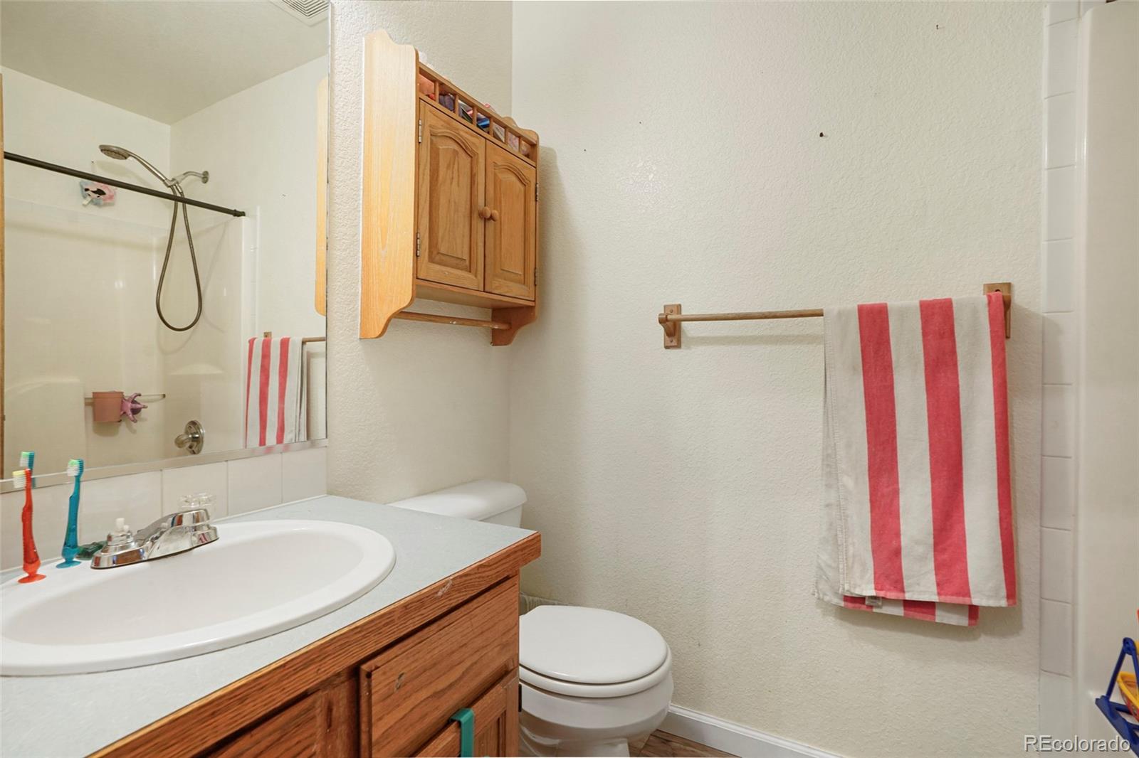 1200 7th Street Fort Lupton, CO 80621 - Photo 13 of 17 a bathroom with a sink and a mirror