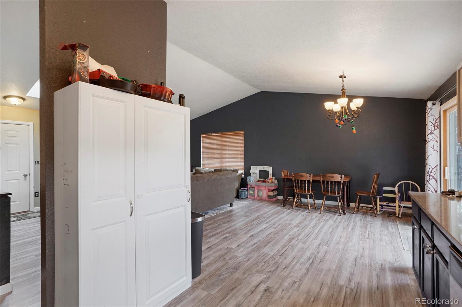 1200 7th Street Fort Lupton, CO 80621 - Photo 4 of 17 a dining room with furniture and wooden floor