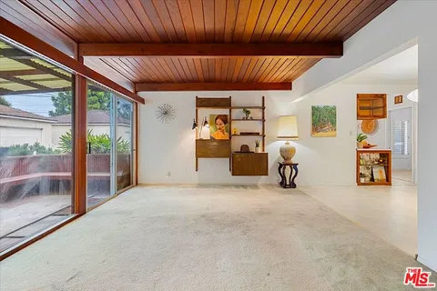 a view of a livingroom with furniture and staircase