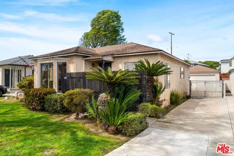 a front view of house with yard and outdoor seating
