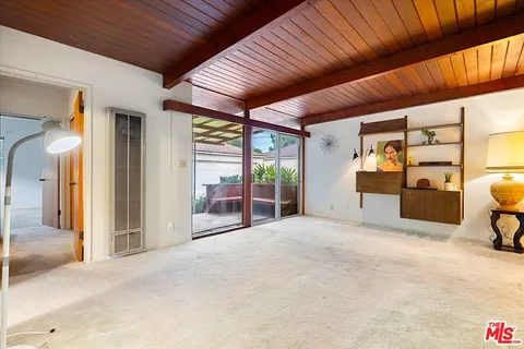 a view of a livingroom with wooden floor and furniture