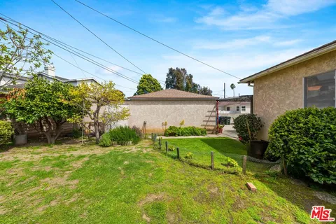 a view of backyard with a chair and table