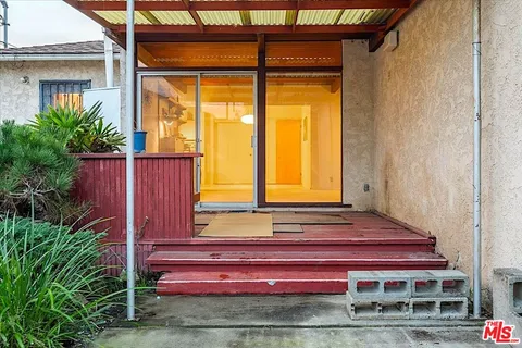 a couple of potted plants in front of door