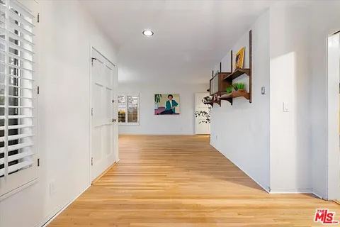 a view of a hallway view with wooden floor and staircase