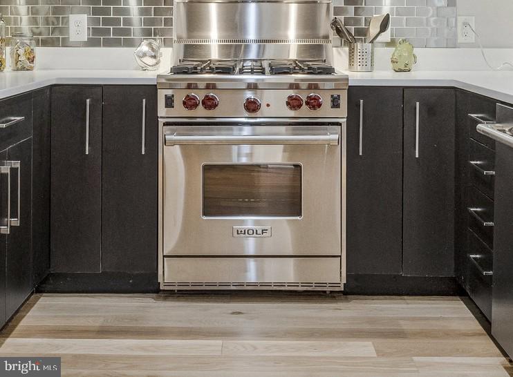 1610 North Queen Street, Unit 211 Arlington, VA 22209 - Photo 11 of 43 a stove top oven sitting inside of a kitchen