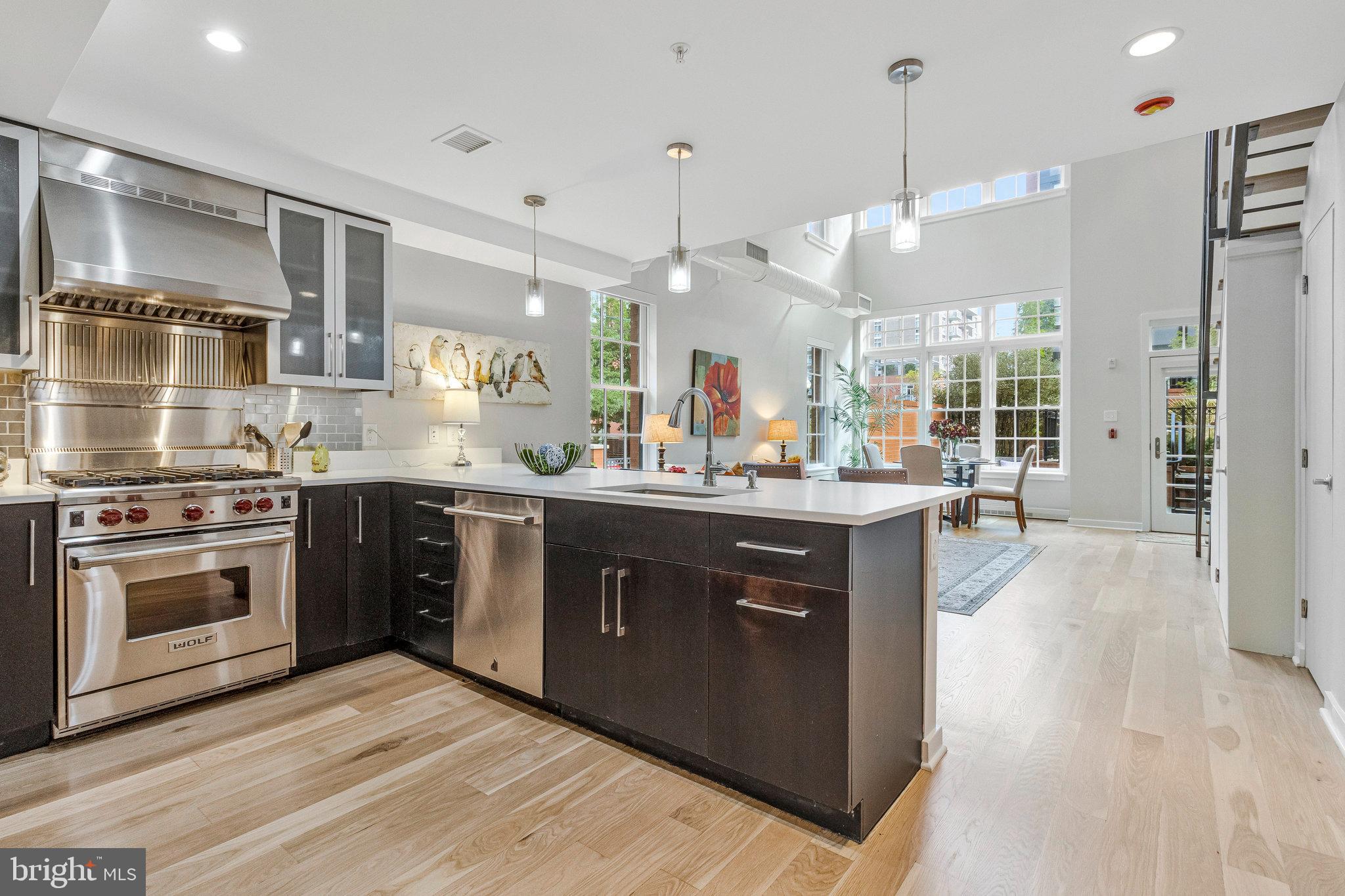 1610 North Queen Street, Unit 211 Arlington, VA 22209 - Photo 13 of 43 a kitchen with a sink stove and cabinets
