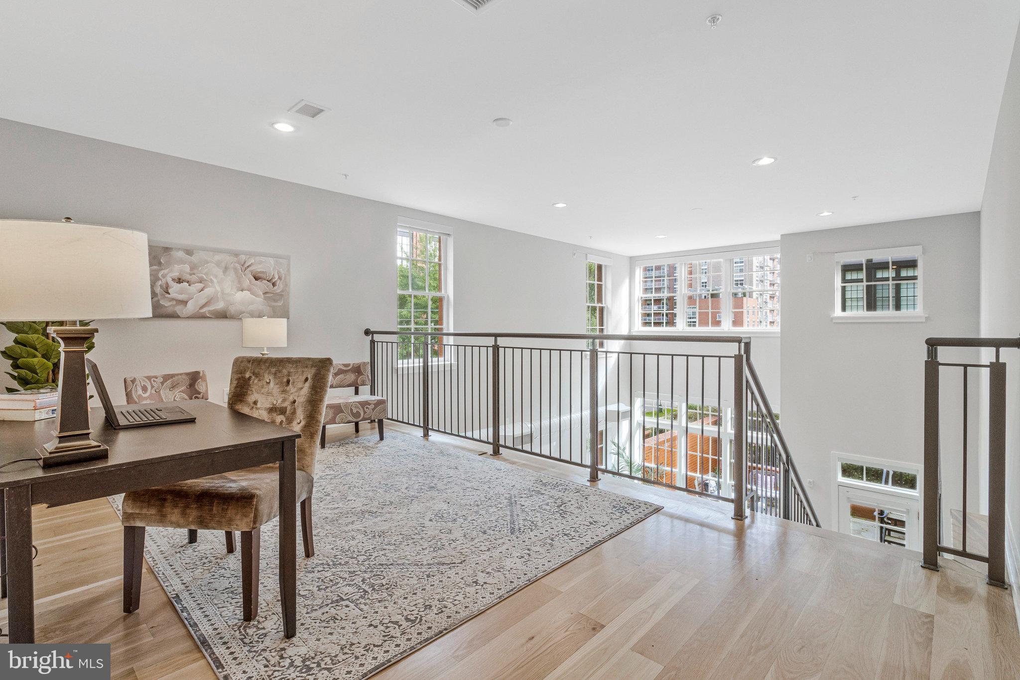 1610 North Queen Street, Unit 211 Arlington, VA 22209 - Photo 15 of 43 a view of a workspace with furniture and wooden floor