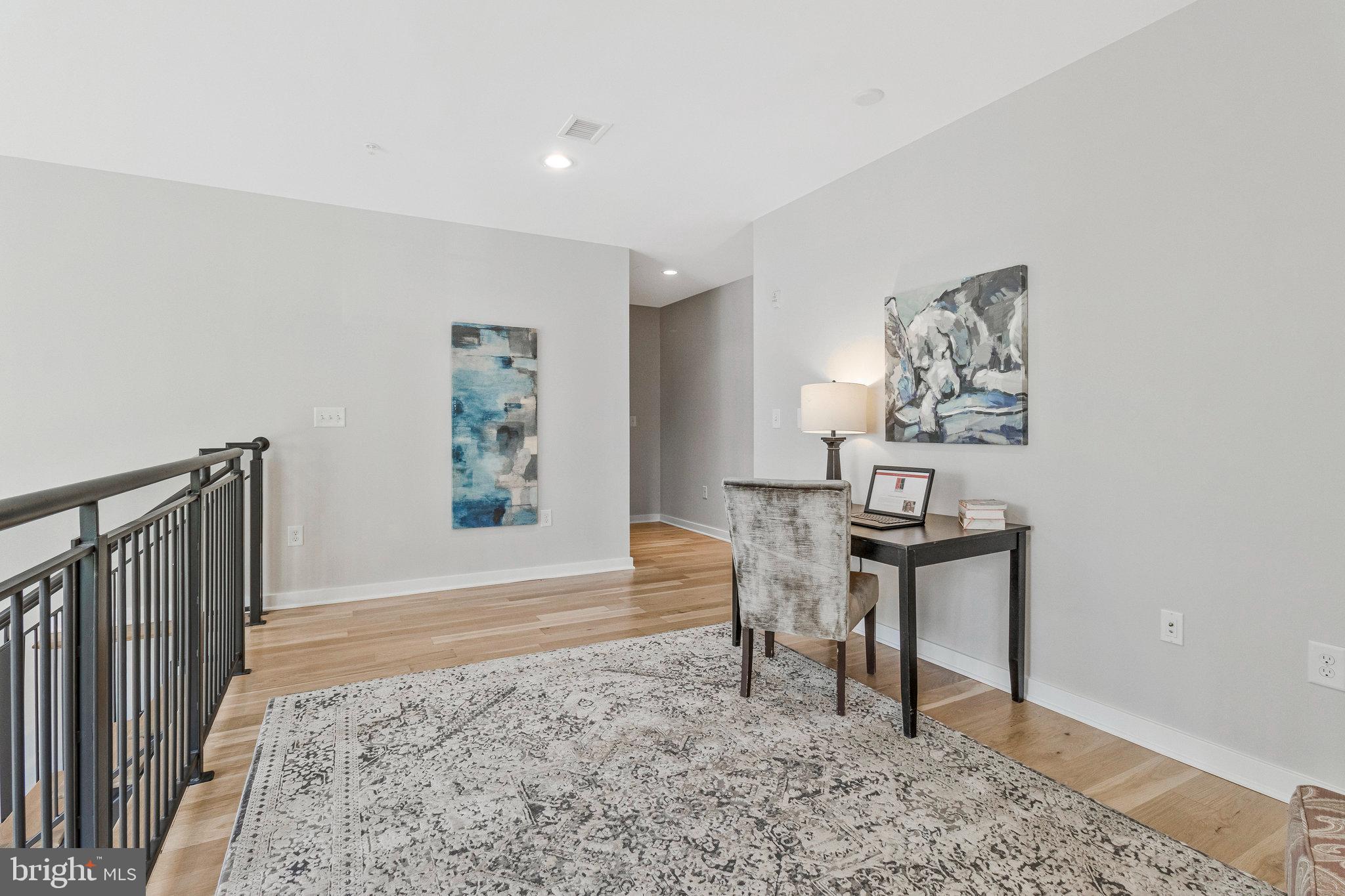 1610 North Queen Street, Unit 211 Arlington, VA 22209 - Photo 19 of 43 a view of a livingroom with furniture and wooden floor