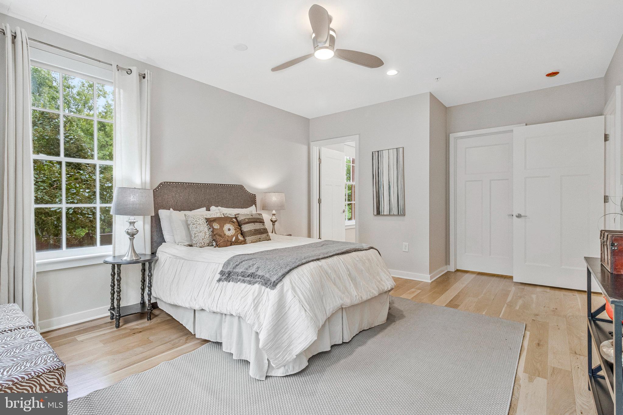 1610 North Queen Street, Unit 211 Arlington, VA 22209 - Photo 20 of 43 a bedroom with a large bed and a window