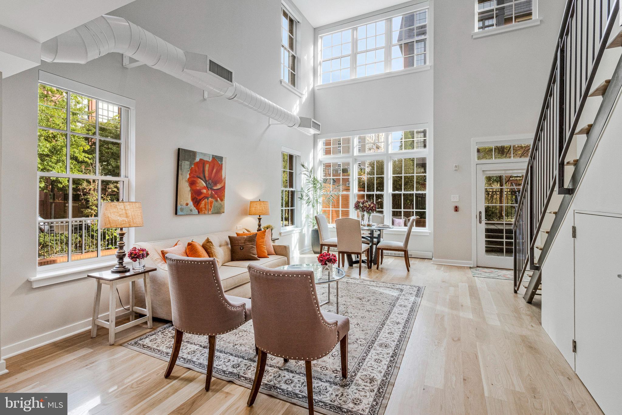 1610 North Queen Street, Unit 211 Arlington, VA 22209 - Photo 2 of 43 a living room with furniture and a window