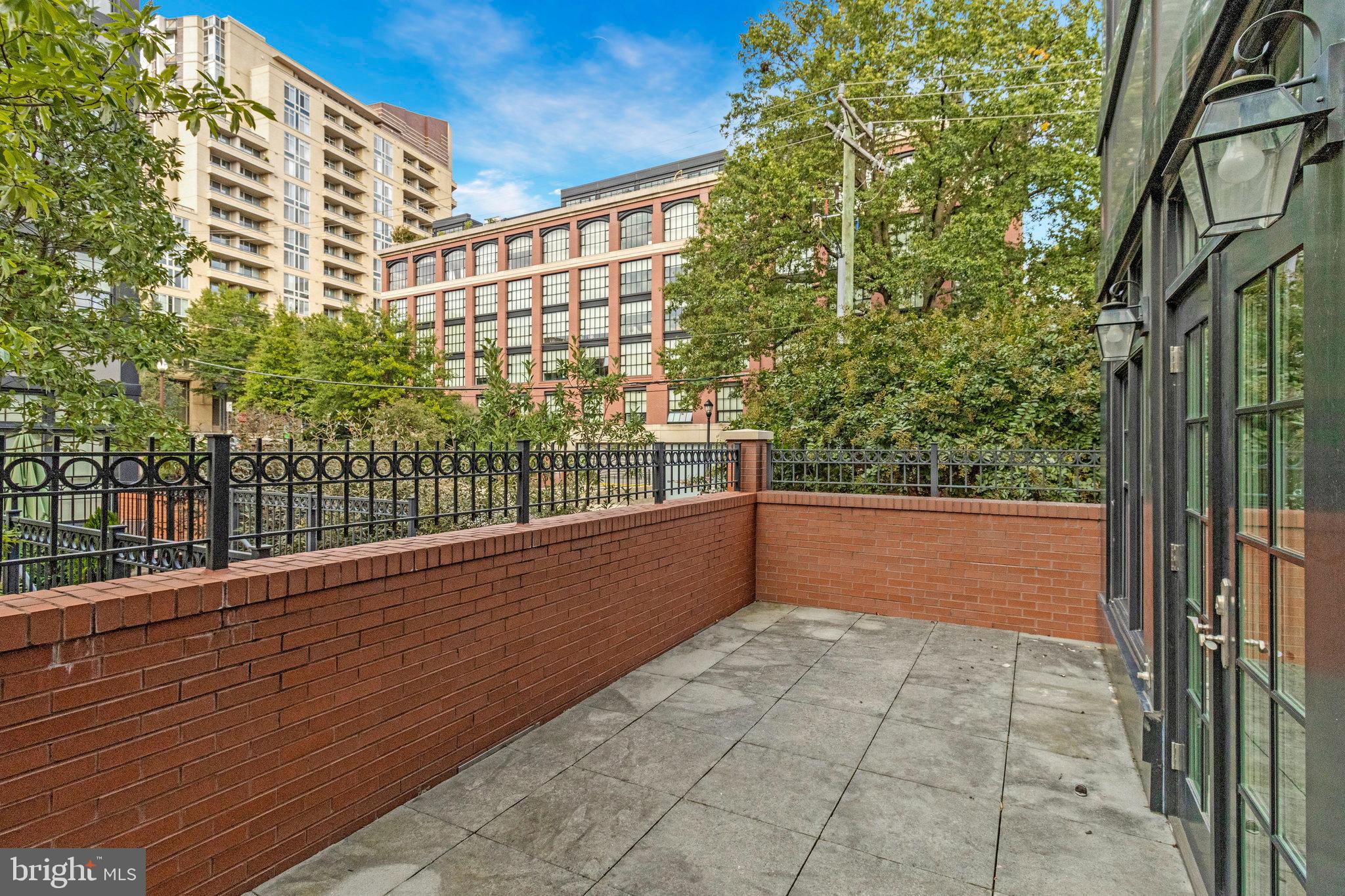 1610 North Queen Street, Unit 211 Arlington, VA 22209 - Photo 27 of 43 a view of balcony with floor to ceiling windows and wooden fence