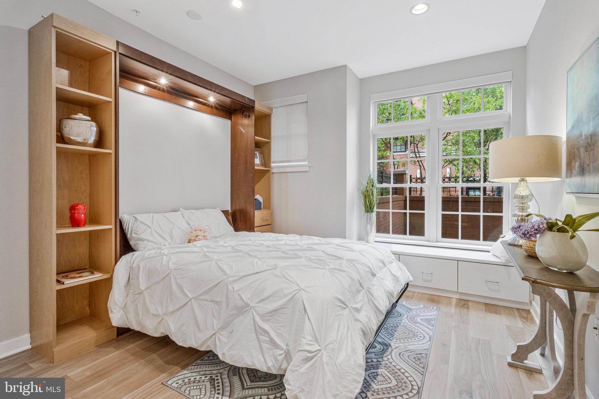 1610 North Queen Street, Unit 211 Arlington, VA 22209 - Photo 29 of 43 a bedroom with a bed and a window