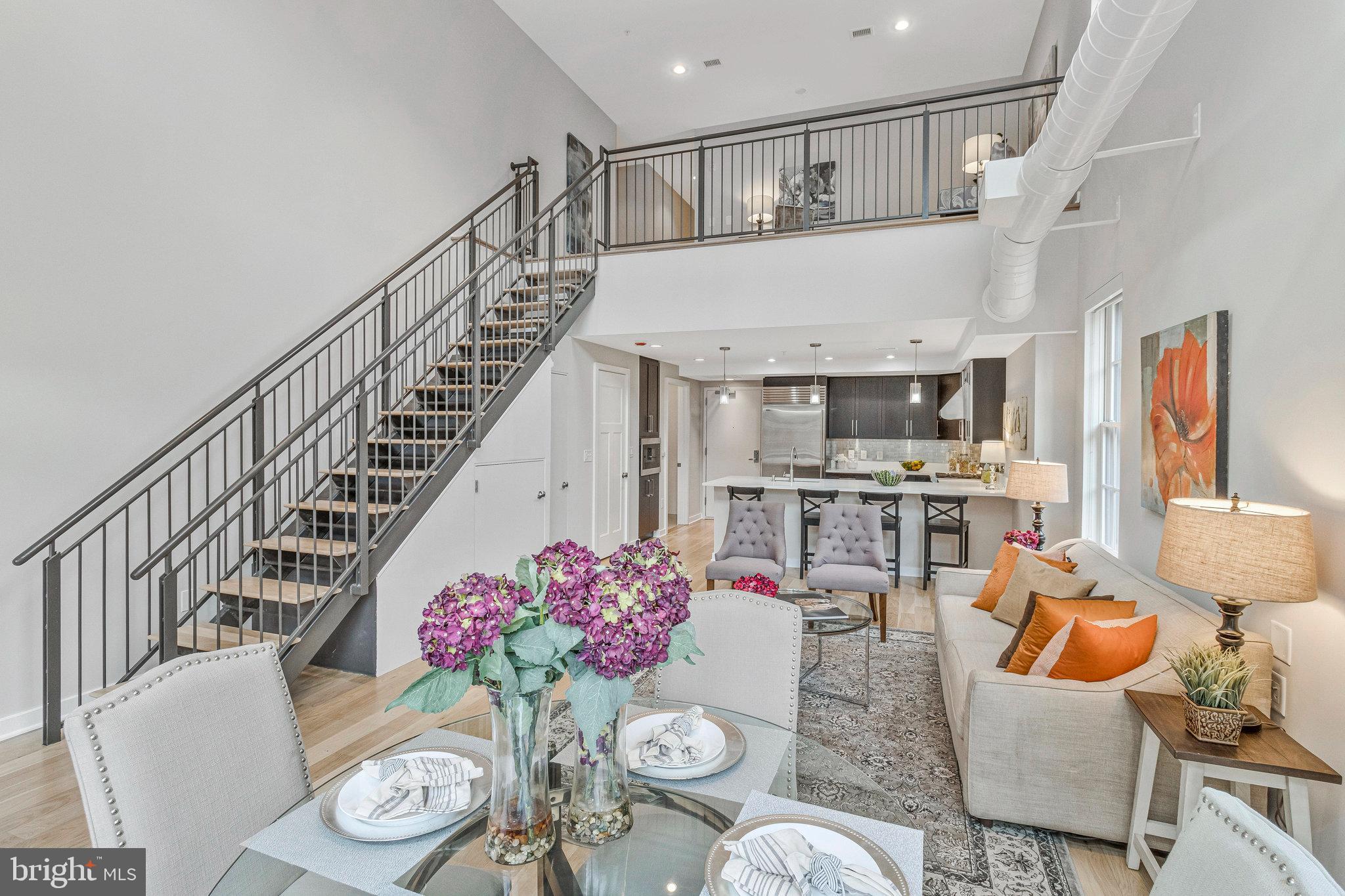 1610 North Queen Street, Unit 211 Arlington, VA 22209 - Photo 3 of 43 a living room with furniture kitchen view and a table