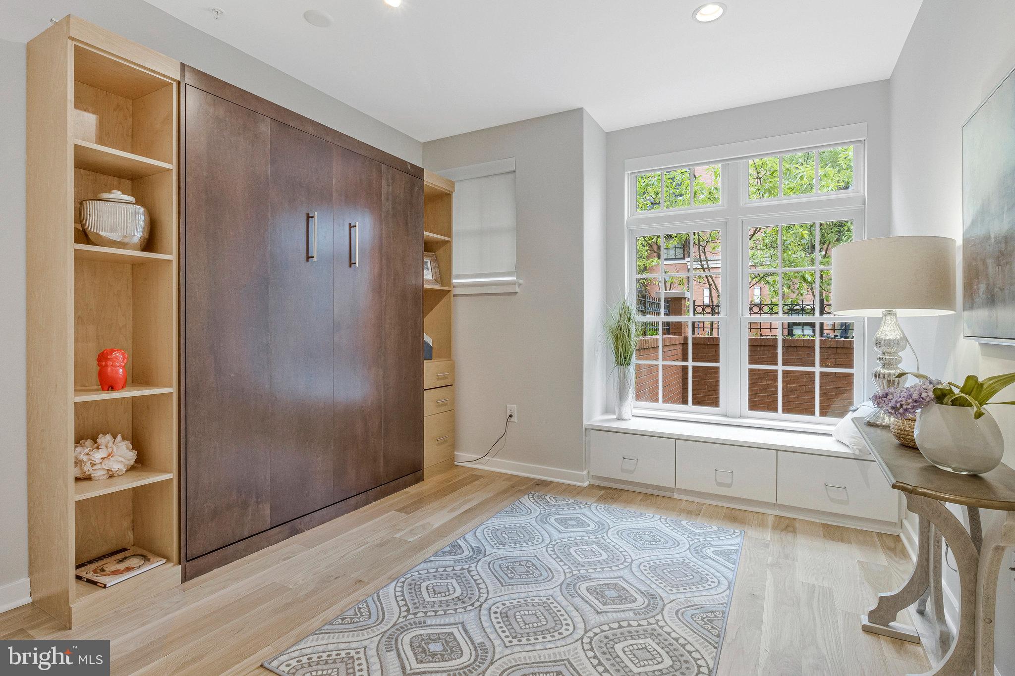 1610 North Queen Street, Unit 211 Arlington, VA 22209 - Photo 32 of 43 a view of an entryway with wooden floor and a cabinet