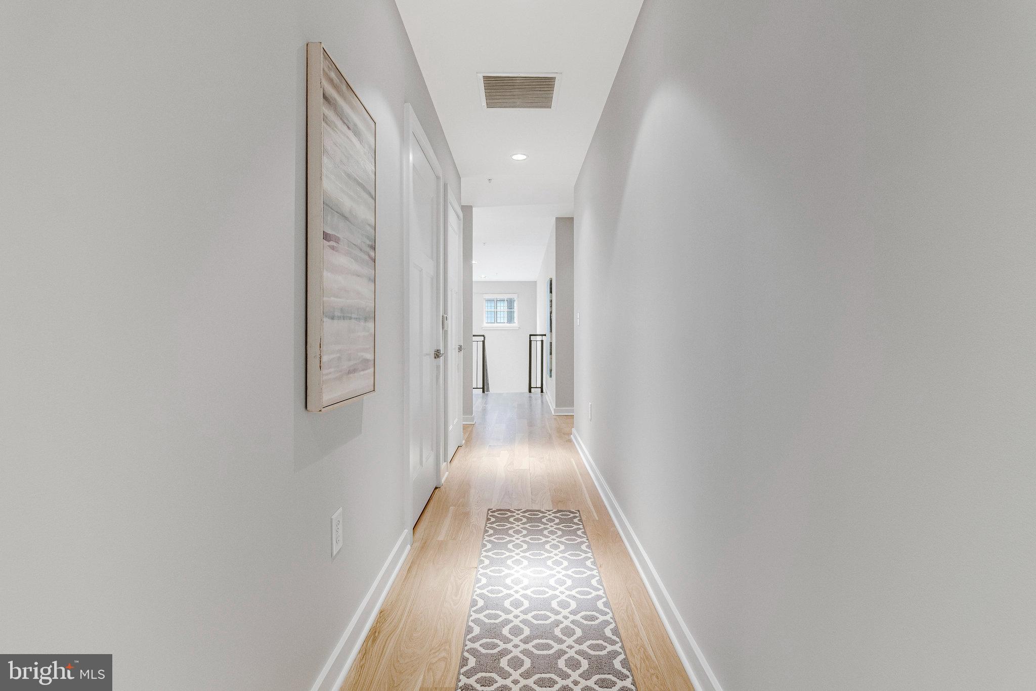 1610 North Queen Street, Unit 211 Arlington, VA 22209 - Photo 33 of 43 a view of a hallway with wooden floor
