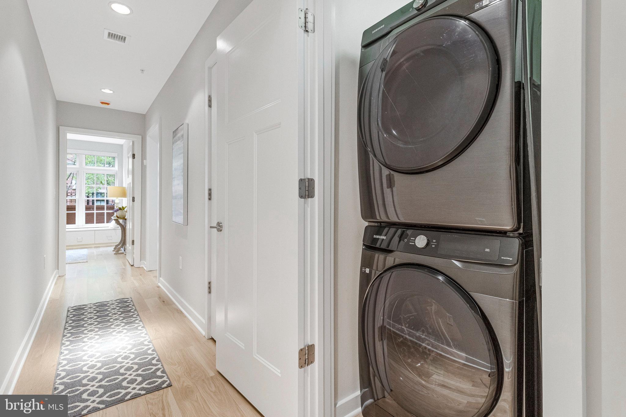 1610 North Queen Street, Unit 211 Arlington, VA 22209 - Photo 34 of 43 a view of a hallway with washer and dryer