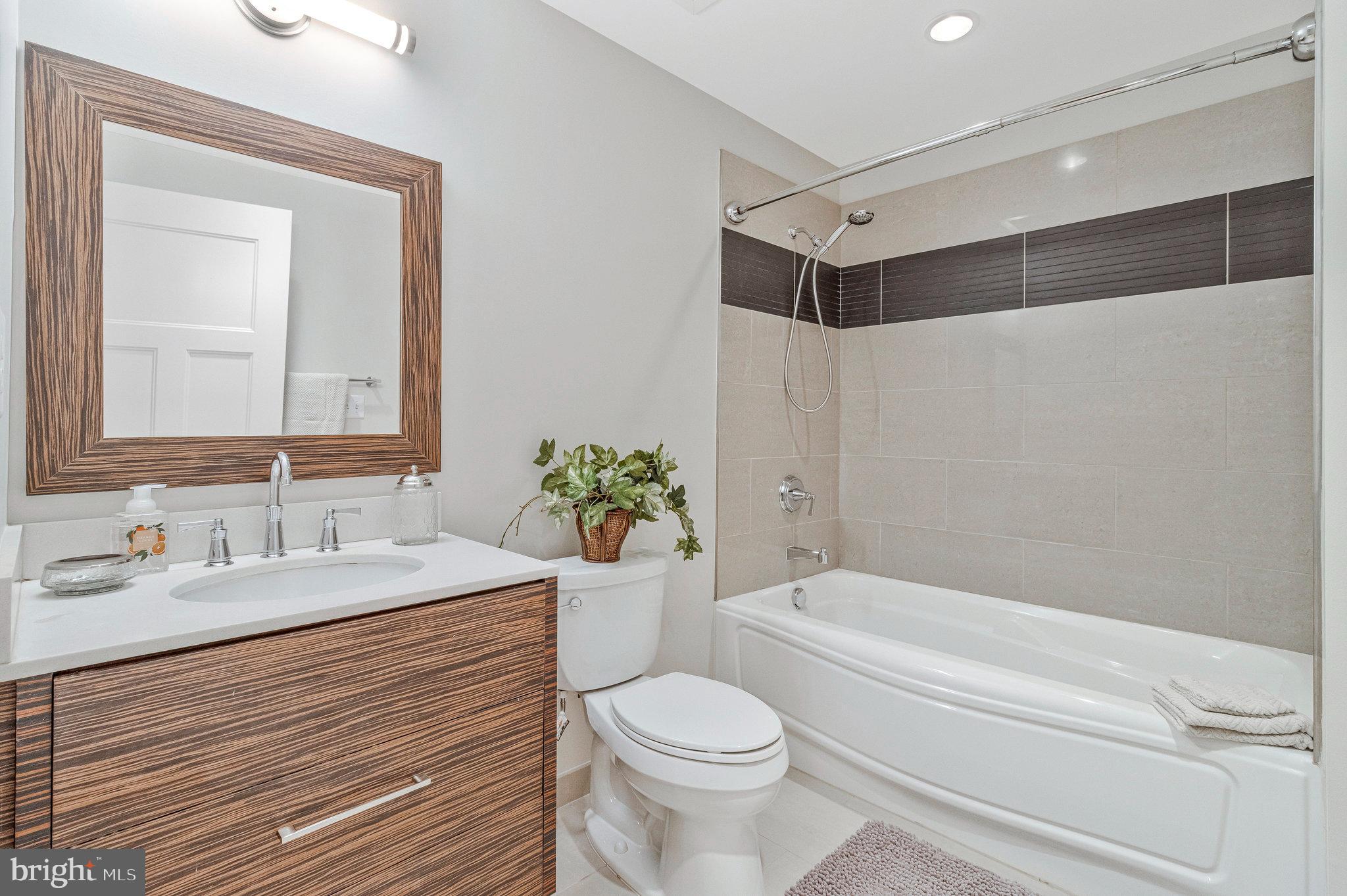 1610 North Queen Street, Unit 211 Arlington, VA 22209 - Photo 35 of 43 a bathroom with a sink toilet and shower