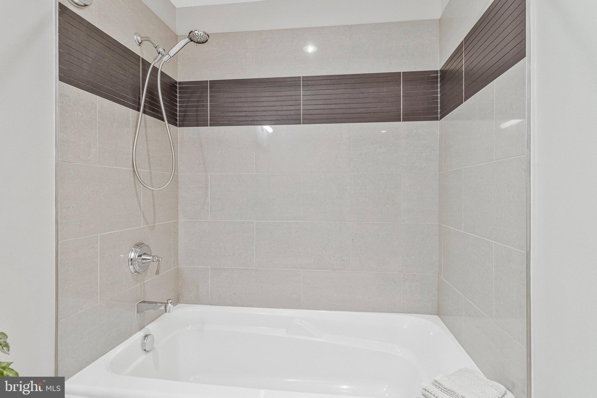 1610 North Queen Street, Unit 211 Arlington, VA 22209 - Photo 36 of 43 a bathroom with a shower and a shower