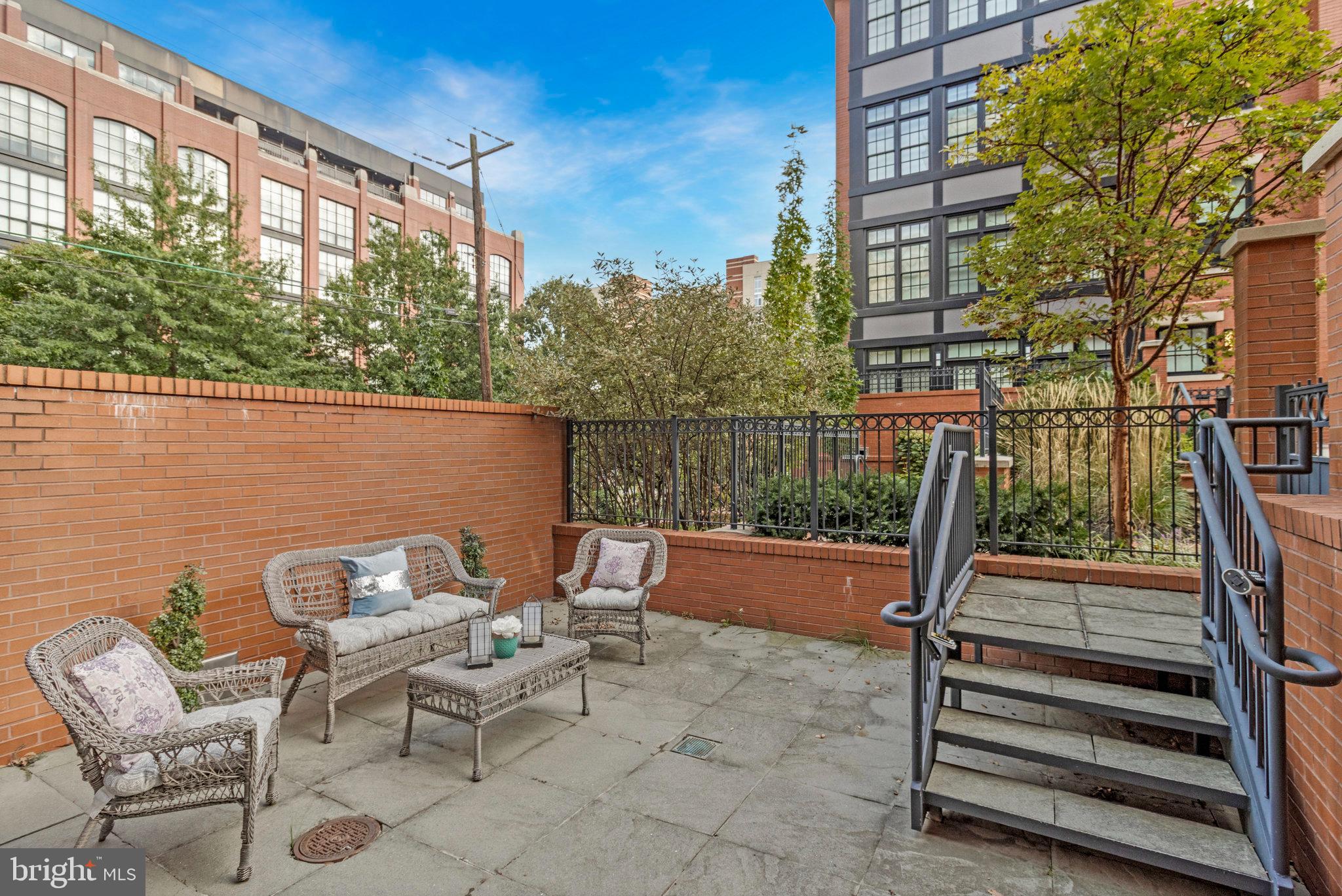 1610 North Queen Street, Unit 211 Arlington, VA 22209 - Photo 38 of 43 a view of a patio with a table and chairs
