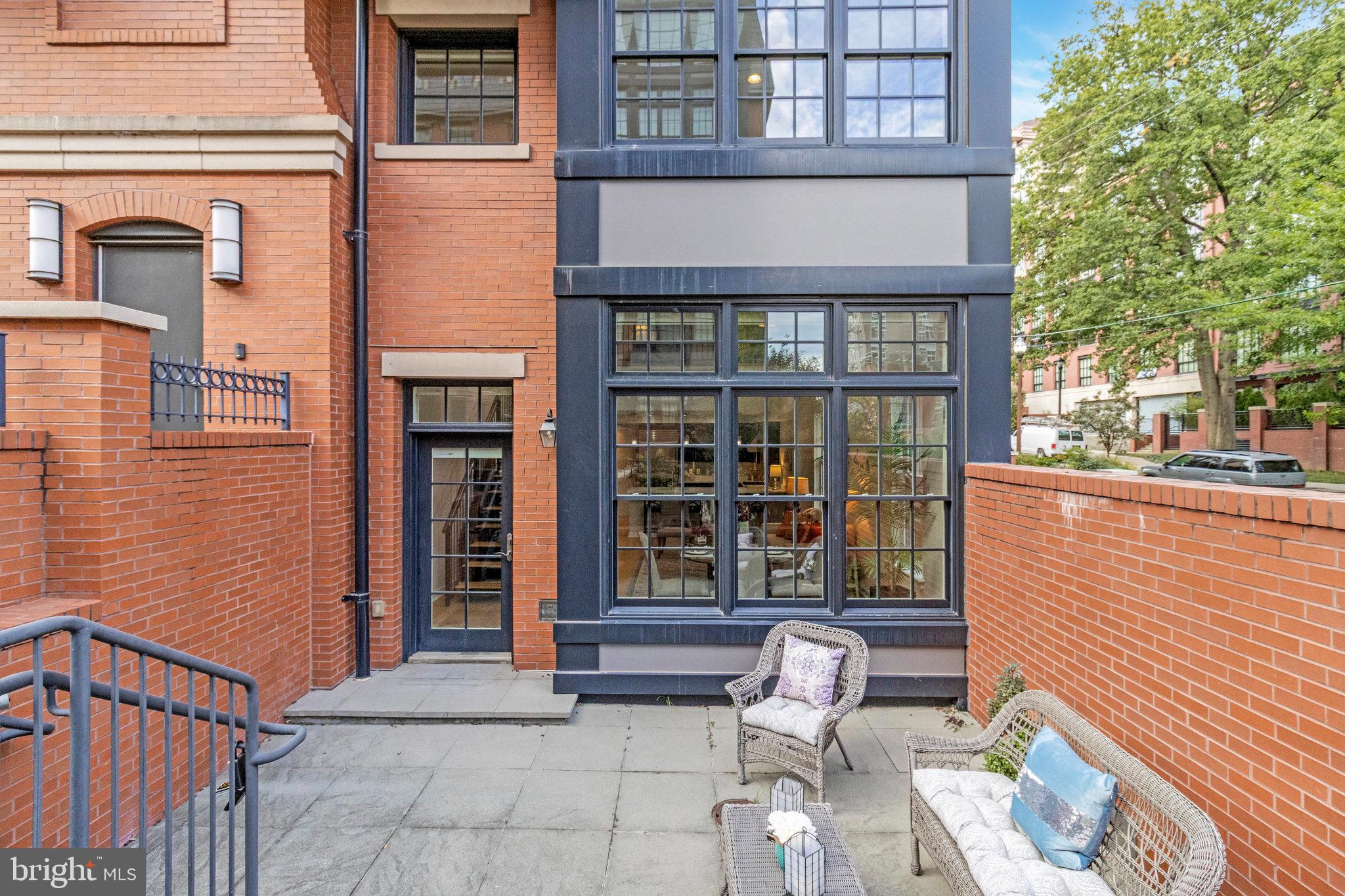 1610 North Queen Street, Unit 211 Arlington, VA 22209 - Photo 40 of 43 a front view of a brick building with many windows